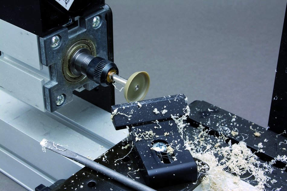 Lathe in action, making of a propeller for a plane modell out of plastic
